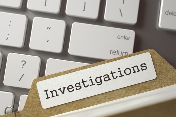 Sort Index Card with Investigations on laptop keyboard